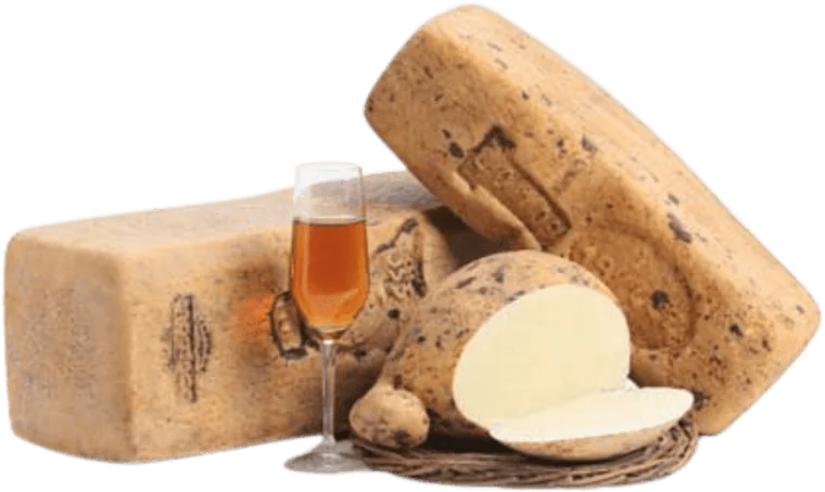 Wheels of aged Sicilian cheese with a glass of dessert wine